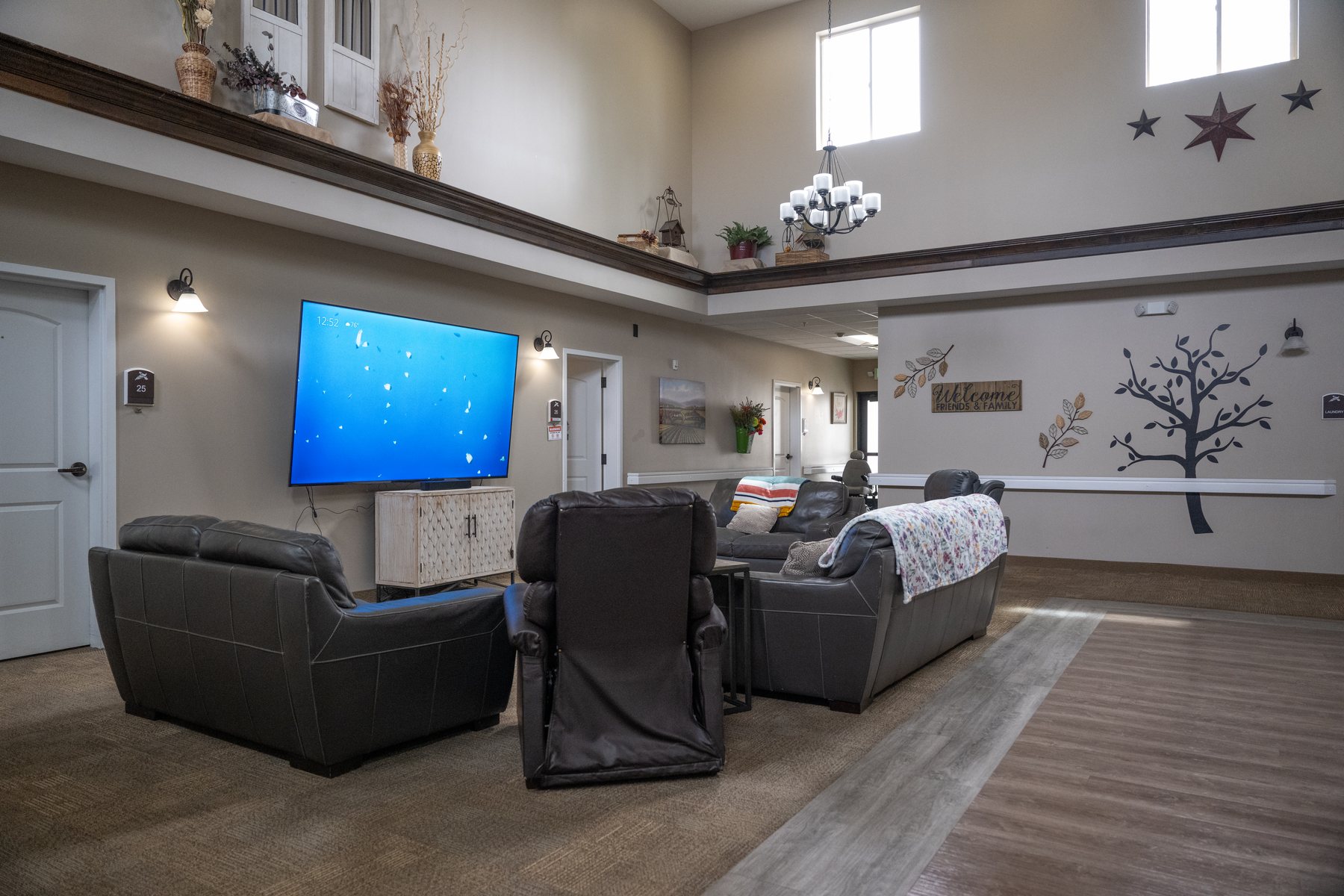 Common area with fireplace, seating, and dining tables at Pheasant View Assisted Living